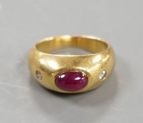 A yellow metal, cabochon ruby and two stone diamond chip set ring, size E/F, gross weight 6.6 grams.